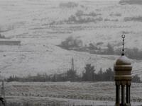 Snow covers the minaret of a mosque in Damascus as the Syrian capital was lashed by a snowstorm which disrupted traffic but brought some relief from a drought which has gripped the country for the past four years.