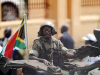 A South African soldier rides a commando truck as they follow the South Africa's President Jacob Zuma's arrival to the ceremony in the capital Juba.