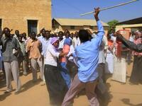 A Sudanese man holding a cane scuffles with university students after clashes erupted during a protest 
against the visit of Darfur mediators from Qatar and the UN outside the University of Zalingei in western 
Darfur.