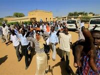 Sudanese students shout slogans during a protest against the visit of Darfur mediators from Qatar and the UN outside the University of Zalingei.