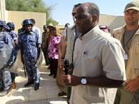 Djibril Bassole, chief negotiator for the UN and the African Union, is surrounded by bodyguards and Sudanese policemen as he prepares to address students protesting outside the University of Zalingei.