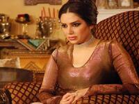 This regal Syrian actress takes her seat.
