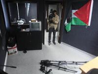 PALESTINE: A press cameraman films damages at a studio at the Palestinian media centre after unknown men attacked its offices, January 26, 2011.