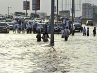 SAUDI ARABIA: Saudi motorists stop their vehicles on the edge of a flooded street following heavy rain in the Red Sea port city of Jeddah, January 26, 2011.