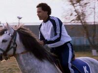 Young Muammar Gaddafi riding horse