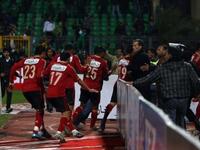Al-Ahly players abandon the pitch as Al-Masry fans rush to the locker-room. The 'big team'
face-off with a local home team, underdog, victor-  Al Masry - got ugly when hardcore 'groupies' in Egypt known as 'Ultras' kicked off. These fanatic followers of fanclubs, introduced grievances from Tahrir, Masepro,& propaganda into friendly football. 
