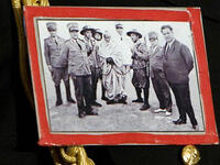 Brazenly sports this self-fashioned badge of Omar Mukhtar national hero who died resisting Italian rule of Libya ( on a visit to Berlusconi&amp;#039;s Italy no less)