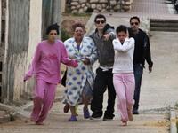 Israelis run to take cover in a shelter during a Palestinian rocket attack on the southern Israeli city of Beersheva, about 40 kilometres from the Gaza Strip as two Grad rockets fired by Gaza militants slammed into Beersheva.