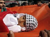 Palestinian mourners carry the body of 11-year-old Mohammed al-Helu during a funeral in Gaza City.
