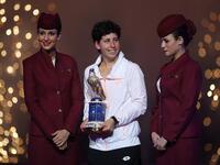 Carla Suarez Navarro of Spain poses with her trophy after winning against Jelena Ostapenko of Latvia their Qatar Open final tennis match on February 27, 2016 in the Qatari capital Doha. Spain's Carla Suarez Navarro came from a set behind against Latvian teenager Jelena Ostapenko to win the Qatar Open, 1-6, 6-4, 6-4.