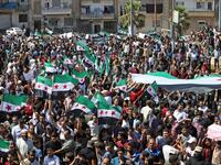 Syrian protesters wave the flag of the opposition as they demonstrate against the regime and its ally Russia, in the rebel-held city of Idlib on September 7, 2018. (OMAR HAJ KADOUR / AFP)