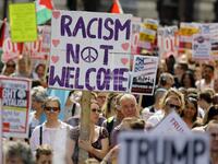 Protesters against the UK visit of US President Donald Trump holding up placards as they take part in a march and rally in London on July 13, 2018.  (Tolga AKMEN / AFP)