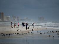 People look out to the Gulf of Mexico as Hurricane Michael approaches October 9, 2018 in Panama City Beach, Florida Hurricane Michael strengthened to a Category 2 storm with winds over 100 miles per hour on Tuesday. (Brendan Smialowski / AFP)