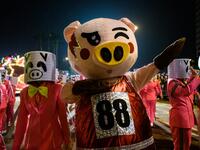 Performers wear pig customers as they take part in the annual Lunar New Year parade in the Kowloon district of Hong Kong on February 5, 2019, to mark the Year of the Pig. 
Anthony WALLACE / AFP