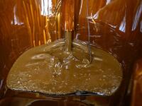 Naftalan crude oil flows from a tap to fill a bathtub during a treatment session at Sehirli Naftalan Health Center, some 300 kilometres (186 miles) from capital Baku, on March 21, 2019. Immersed up to her neck in crude oil, a Russian woman suffering from joint disease smiles in delight, confident that the treatment at a spa in northwestern Azerbaijan will cure her painful condition.  Mladen ANTONOV / AFP