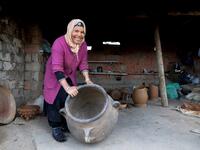 Sabiha Ayari, a Tunisian potter in her fifties, works in the village of Sejnane in the northern Tunisian province of Bizerte, about 120 kilometres (75 miles) west of the capital Tunis.  FETHI BELAID / AFP