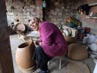 Sabiha Ayari, a Tunisian potter in her fifties, works in the village of Sejnane in the northern Tunisian province of Bizerte, about 120 kilometres (75 miles) west of the capital Tunis.  FETHI BELAID / AFP