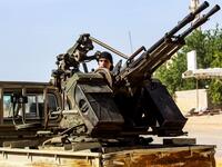A Libyan fighter loyal to the Government of National Accord (GNA) mans a turret mounted on the back of a pickup truck during clashes with forces loyal to strongman Khalifa Haftar south of the capital Tripoli's suburb of Ain Zara, on April 10, 2019. Mahmud TURKIA / AFP