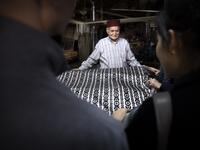 Abdelkader Ouazzani, the last of Morocco's brocade master weavers, displays tapestry at his workshop in the old city of Fez on April 10, 2019. His skilfull hands intricately create shimmering silk fabrics, enhanced with gold or silver thread, for bridal jewellery, designer creations or high-end furnishings. FADEL SENNA / AFP