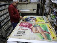Abboudi Abu Jawdeh shows part of his vintage cinema poster collection at his office in the Lebanese capital Beirut  JOSEPH EID / AFP
