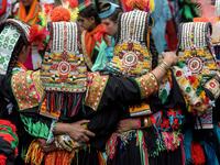 Kalash women wearing traditional dresses dance as they celebrate 'Joshi', a festival to welcome the arrival of spring, at Bumburate village in the mountainous valleys in northern Pakistan.  AAMIR QURESHI / AFP