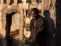 Domingo Tomas, a former soldier with the Angolan Army and now part of a group of homeless people living in a building damaged during the Angolan civil war.  RODGER BOSCH / AFP