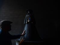 A pilgrim touches the effigy of the Rocio Virgin at the church of the village of El Rocio on June 10, 2019. CRISTINA QUICLER / AFP