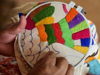 Mexican artisan Glafira Candelaria Jose, of the Otomi ethnic group, embroiders one of her designs at her workshop in San Nicolas village, in Tenango de Doria, Hidalgo state, Mexico.  Pedro PARDO / AFP