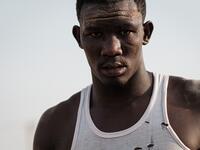 A Sudanese wrestler reacts during a traditional Nuba wrestling match at the Haj Youssef stadium in the district of Khartoum.  Yasuyoshi CHIBA / AFP