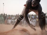 A Sudanese wrestler reacts during a traditional Nuba wrestling match at the Haj Youssef stadium in the district of Khartoum.  Yasuyoshi CHIBA / AFP