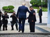 US President Donald Trump steps into the northern side of the Military Demarcation Line that divides North and South Korea, as North Korea's leader Kim Jong Un looks on, in the Joint Security Area (JSA) of Panmunjom in the Demilitarized zone (DMZ) on June 30, 2019.  Brendan Smialowski / AFP