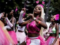 People parade during the Tropical Carnival on July, 7 2019 in Paris.  Kenzo TRIBOUILLARD / AFP