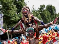 People parade during the Tropical Carnival on July, 7 2019 in Paris.  Kenzo TRIBOUILLARD / AFP