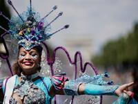People parade during the Tropical Carnival on July, 7 2019 in Paris.  Kenzo TRIBOUILLARD / AFP