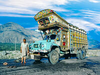 Proud truck driver presents his painted truck at the karacorum highway in Pakistan. The Karakoram highway connects Pakistan with China (Shutterstock)	