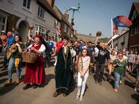 Teams from the villages of Hallaton and Medbourne process to the start point to fight over the 'bottles' (wooden casks) during the Easter Monday Hallaton Hare Pie Scrambling and Bottle Kicking traditional event in the village of Hallaton in central England on April 22, 2019.  Oli SCARFF / AFP