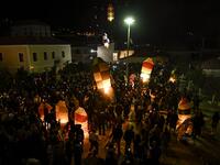 Colorful lanterns lift into in the night sky of Leonidio, a seaside town in the Peloponnese, to mark the Ressurection of Christ celebrated by the Greek Orthodox Church on April 28, 2019.  ARIS MESSINIS / AFP
