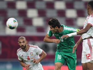 Iraq's Alaa Abdul Zahra (centre) scores from a header against the UAE in Doha on Friday. (AFP)