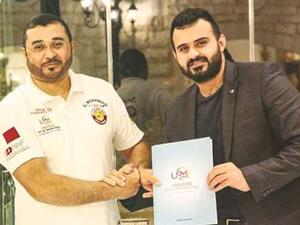  Qatari rally driver Khalid al-Mohannadi (left) with Universal Sports’ marketing director Zaid Yaaroub after signing a sponsorship agreement. (Photo: Gulf Times)