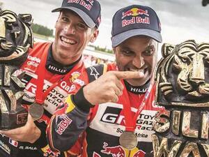 Qatar’s ace rally driver Nasser al-Attiyah (right) and his co-driver Mathieu Baumel of France celebrate after winning the Silk Way Rally in Dunhuang, China, on July 16, 2019 (Photo: Gulf Times)