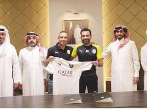 Santi Cazorla (centre) poses with Al Sadd’s head coach Xavi Hernandez (second from right) and other club officials after signing a two-year contract. (Photo: Gulf Times)