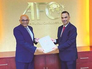 Qatar’s ambassador to Malaysia Fahd bin Mohamed Kafood (right) presents the nation’s bid file for 2027 Asian Cup to AFC Secretary-General Windsor John in Kuala Lumpur. (Photo: Gulf Times)