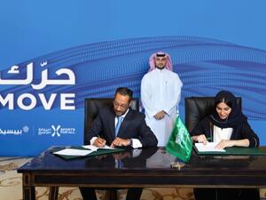 SFA Managing Director Shaima Saleh Al-Husseini and Tamer Mosalam, Gulf & Levant Foods Vice President and Business Unit General Manager at PepsiCo, signing a partnership deal on Sunday. (Courtesy photo)