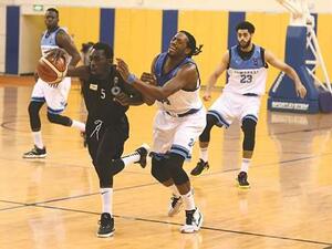 Al Sadd (in black) and Al Wakrah players vying for the ball during their Amir Cup basketball semi-final at the Al Gharafa Sports Club yesterday. (Photo: Shemeer Rasheed)