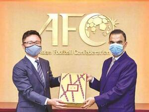 Qatar’s Ambassador to Malaysia Fahd bin Mohammed Kafoud (right) hands over the final part of the bid documents for the 2027 AFC Asian Cup to an Asian Football Confederation official. (Photo: Gulf Times)
