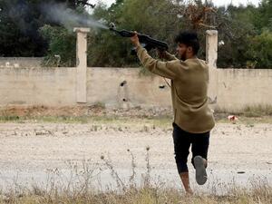 A fighter loyal to the Libyan internationally-recognised Government of National Accord (GNA) fires a Kalashnikov rifle during clashes against forces loyal to strongman Khalifa Haftar, on May 21, 2019. (AFP/ File Photo)
