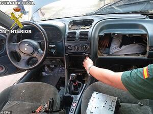 Border police found a man in his twenties squeezed behind a car dashboard. (Daily Mail)