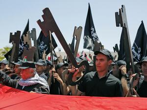 Palestinians hold up paper cutouts of keys as they take part in a rally marking the 71st anniversary of the 'Nakba', or catastrophe, on May 15, 2019 in Ramallah. (AFP)