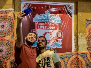 Egyptians take a selfie picture during the pre-dawn 'suhur' meal before a new day of fasting begins, early on May 31, 2019, near a food cart by the name "Liver Fuul". (AFP/ File Photo)