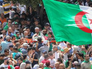 Thousands of people protested for a twentieth consecutive week in Algeria's capital, defying a major police presence just days before the mandate of interim president Bensalah expires. (AFP/ File Photo)
